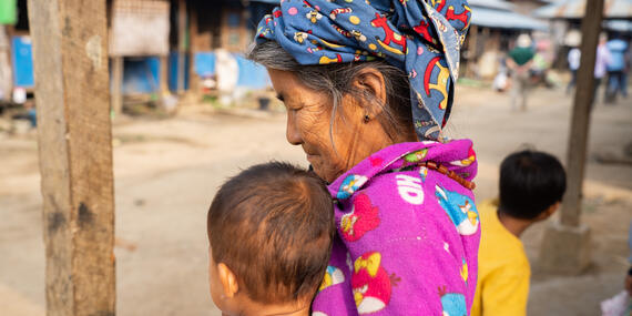 A woman in a displacement camp in Kachin State, Myanmar, holds a young child. 
