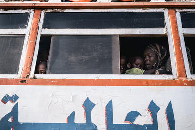 Children, women and men flee the conflict in Sudan in a bus headed for Maban, South Sudan.